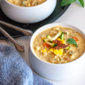 Two bowls of vegan corn and zucchini chowder