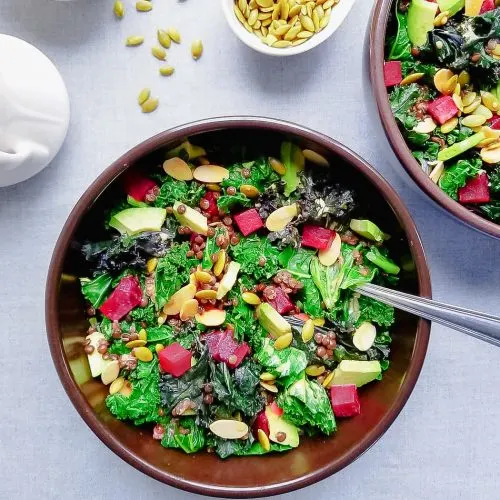 Bowl of Roasted Beet, Kale and Lentil Salad with Golden Dressing, Avocado, Toasted Almonds and Pepitas with Golden Dressing