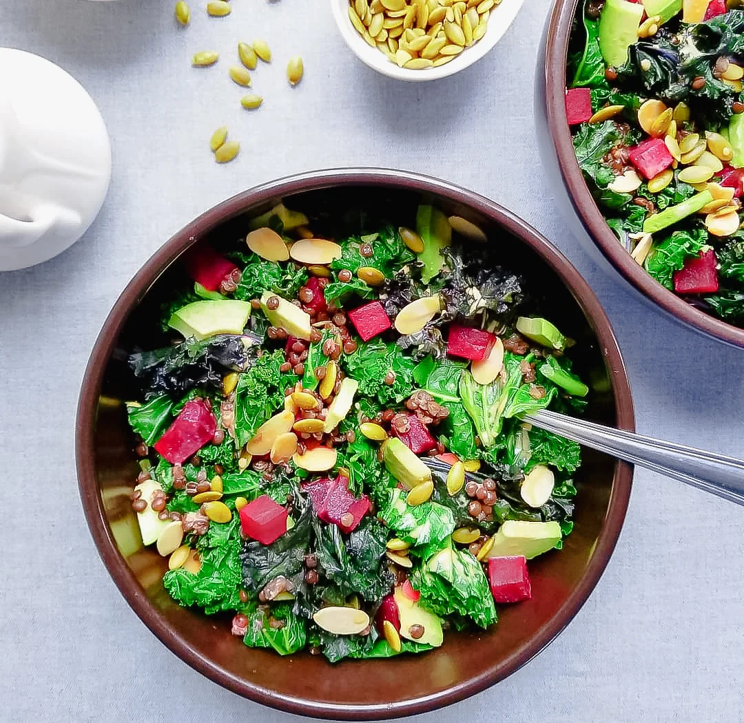 Bowl of Roasted Beet, Kale and Lentil Salad with Golden Dressing, Avocado, Toasted Almonds and Pepitas with Golden Dressing