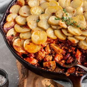 Vegan Savory Skillet Stew with Baby Potato Topping being served from skillet