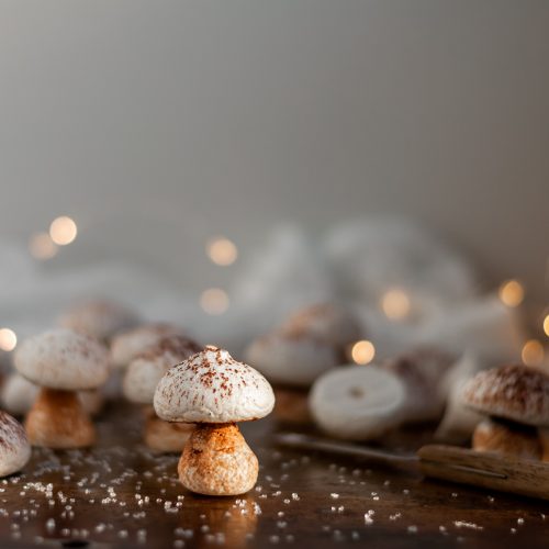 Vegan Meringue Mushroom surrounded by some partly assembled mushrooms