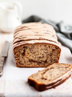 Vegan Cinnamon Swirl Banana Bread glazed, with one slice made