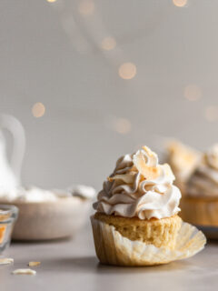 Vegan Coconut Cream Cupcake with the cupcake liner being removed