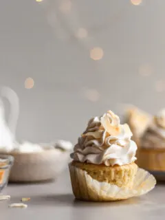 Vegan Coconut Cream Cupcake with the cupcake liner being removed