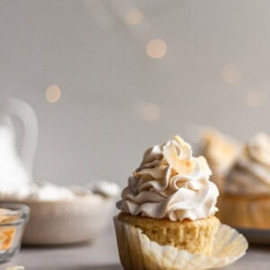 Vegan Coconut Cream Cupcake with the cupcake liner being removed