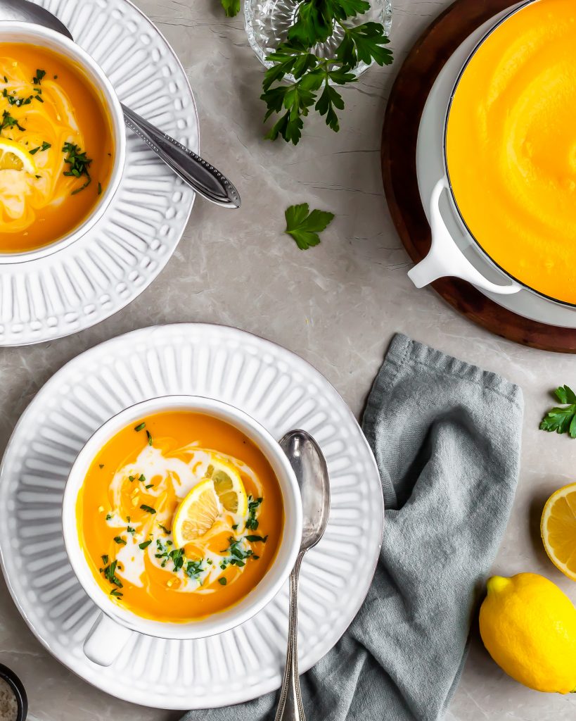 Creamy Curried Carrot, Ginger and Red Lentil Soup served with coconut milk swirl and fresh lemon