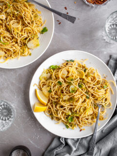 15 Minute Garlicky Breadcrumb Pasta with Shredded Brussels Sprouts served on white plates with chili flakes