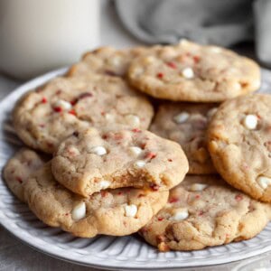 Vegan Strawberries & Cream Chewy Cookies on a plate with a bite taken out of one revealing the chewy interior
