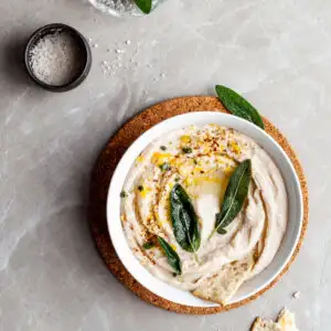 Lemon Sage White Bean Dip garnished with fried sage leaves