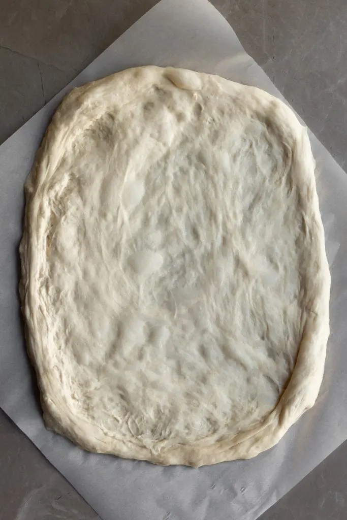 Pizza dough stretched out ready for sauce ad toppings