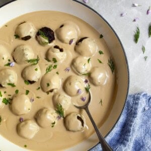 Vegan Swedish Meatballs in white skillet covered in creamy cashew gravy