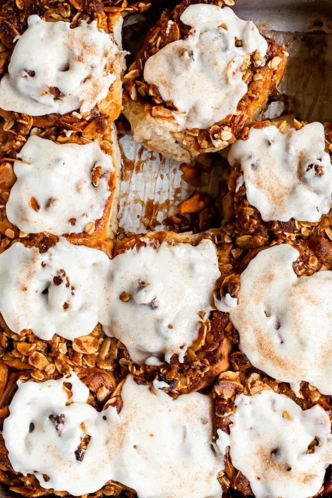 Close up of glazed cinnamon rolls in a pan