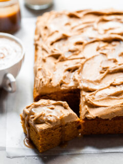 Sheet cake with swirled frosting served with a pumpkin spice latte and butterscotch sauce