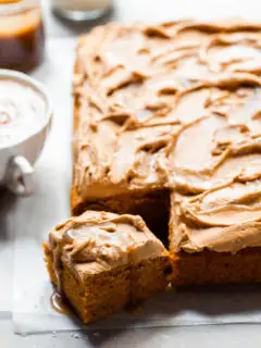Sheet cake with swirled frosting served with a pumpkin spice latte and butterscotch sauce