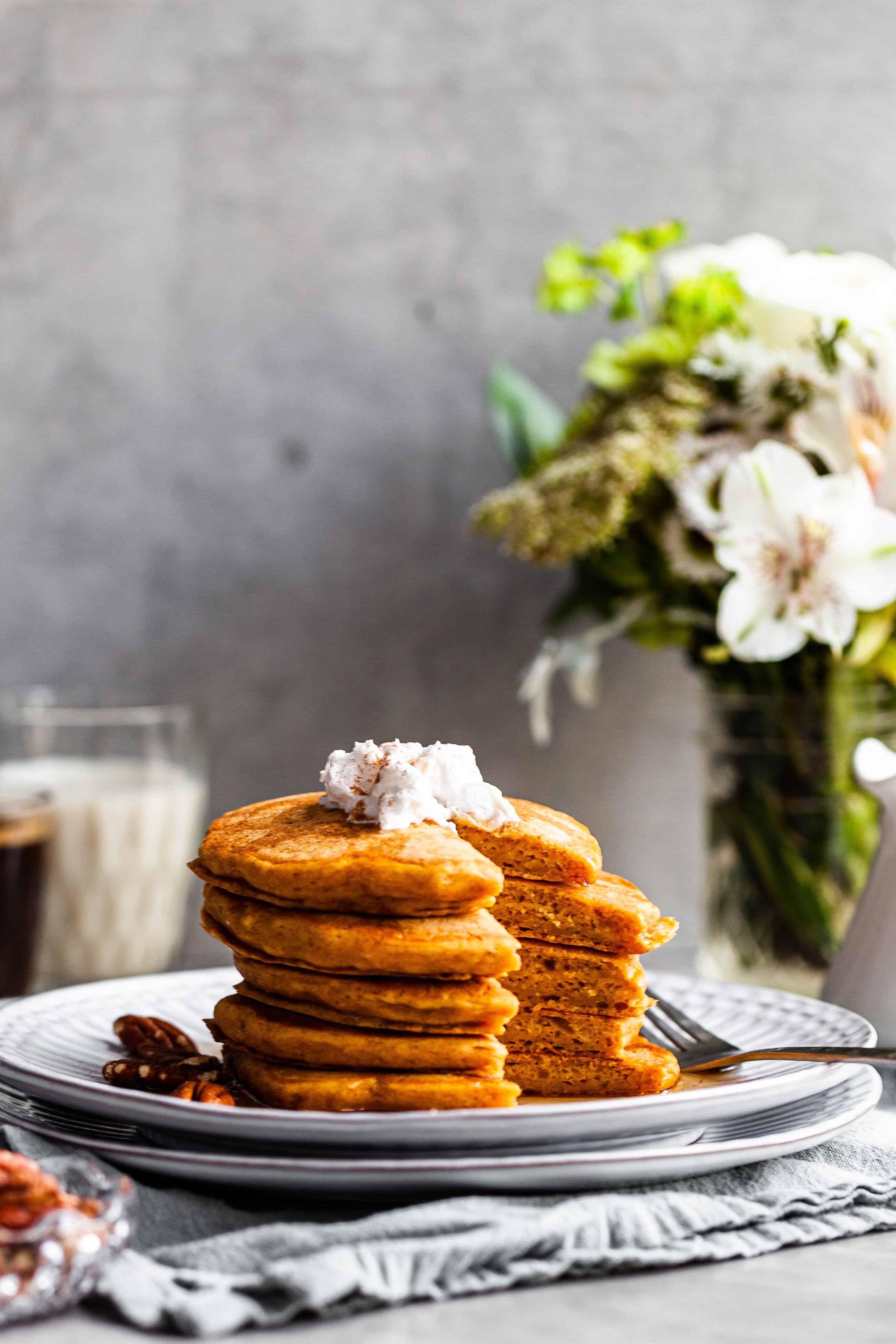 stack of pancakes with the first bite missing