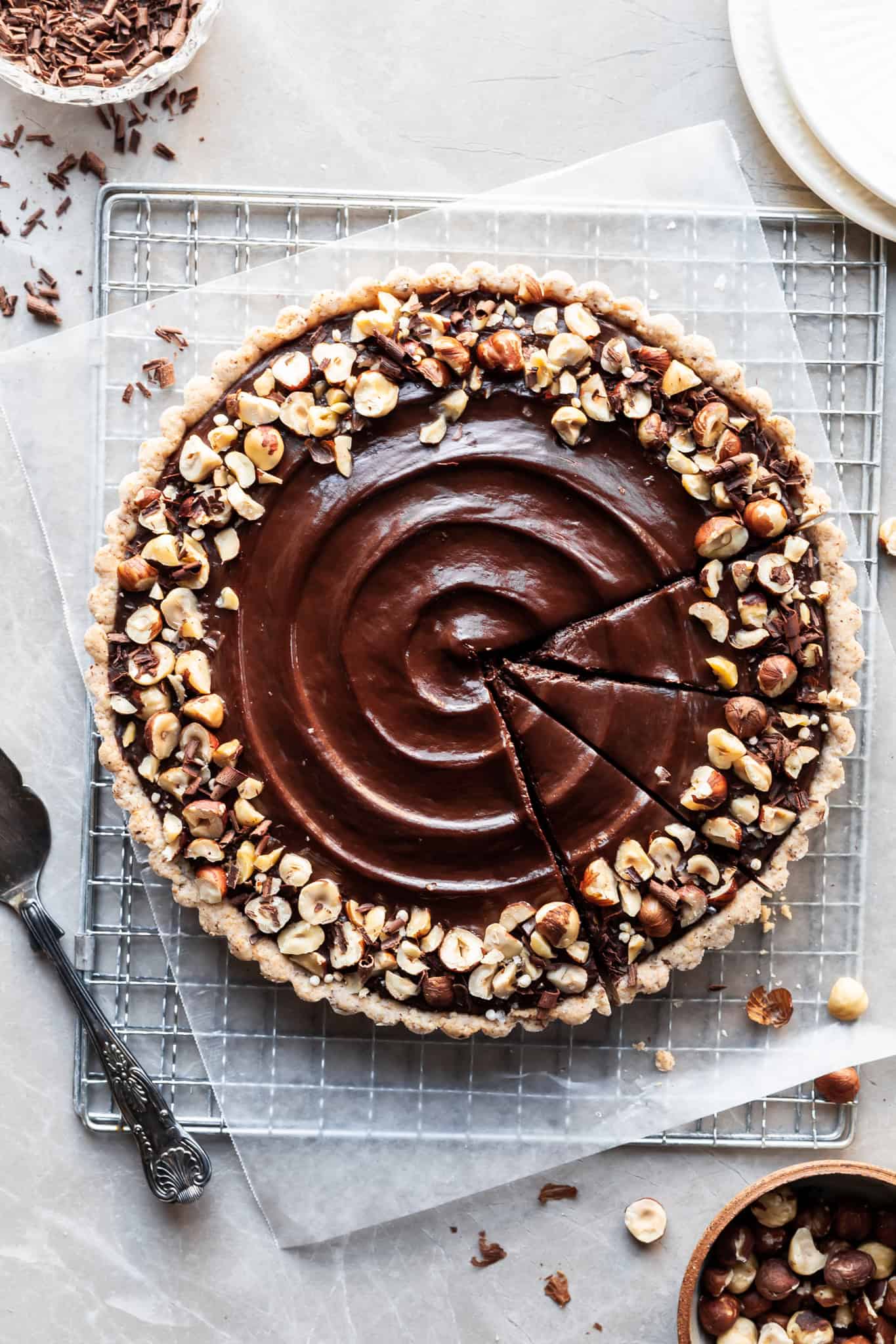 Flatlay of chocolate hazelnut tart with 3 slices made in one quarter not yet served