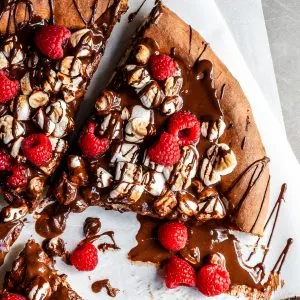 Cropped view of a dessert pizza covered in chocolate and marshmallows