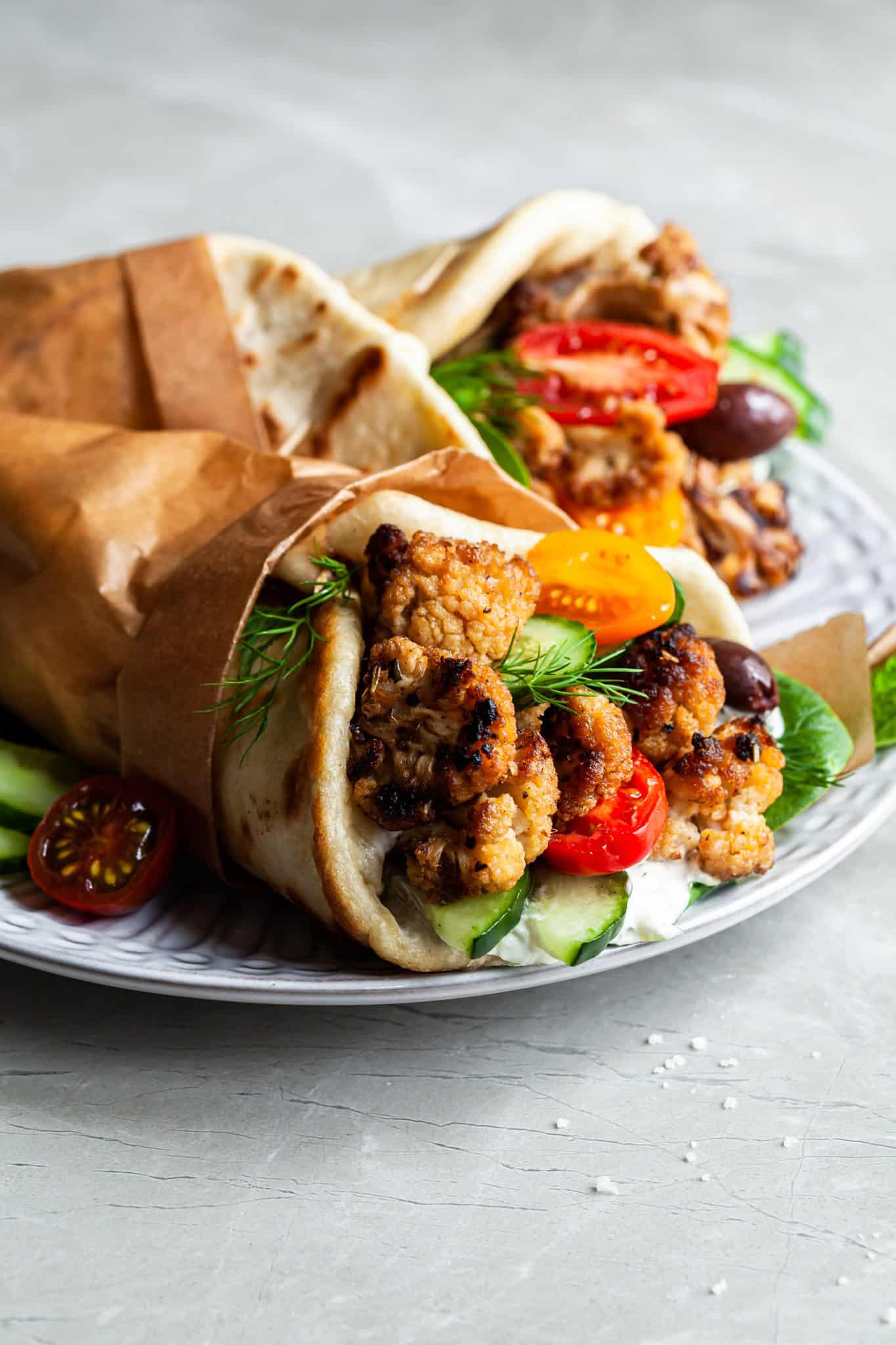 close up of the plant based gyro sandwich fillings showing the cauliflower, tomatoes, tzatziki and cucumber