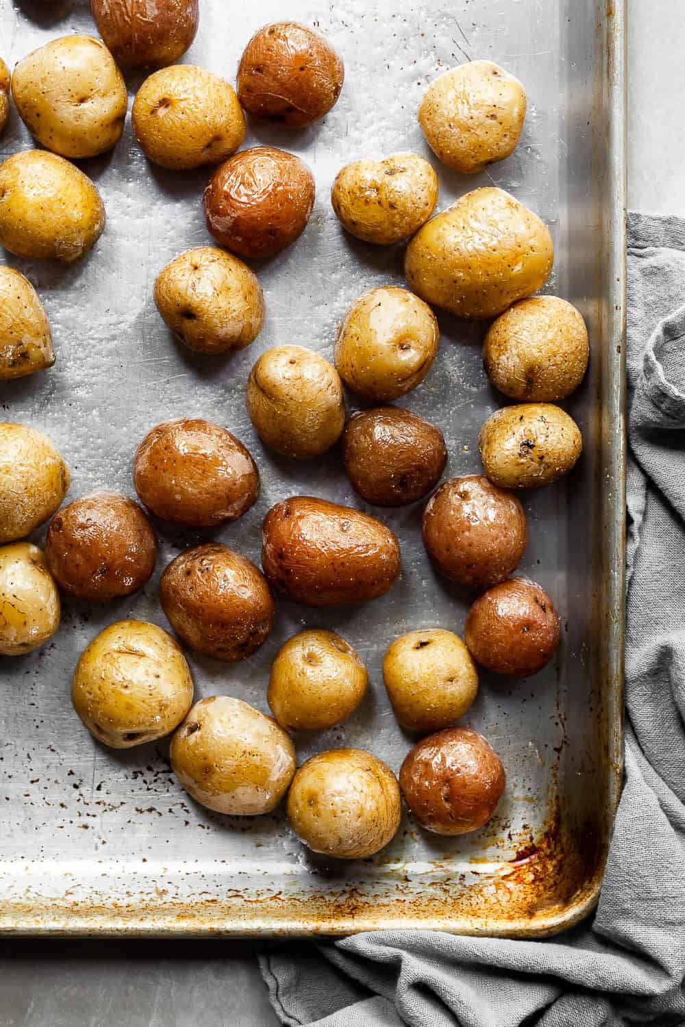 Yellow and red baby potatoes on a baking tray