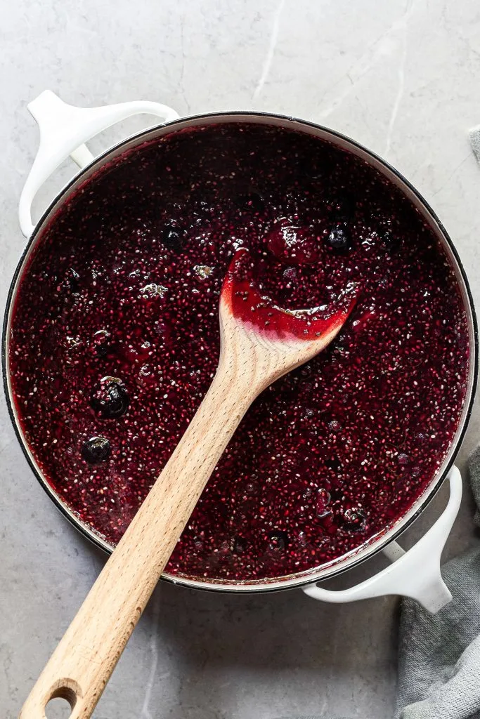 jewel toned berry chia compote in a white pot