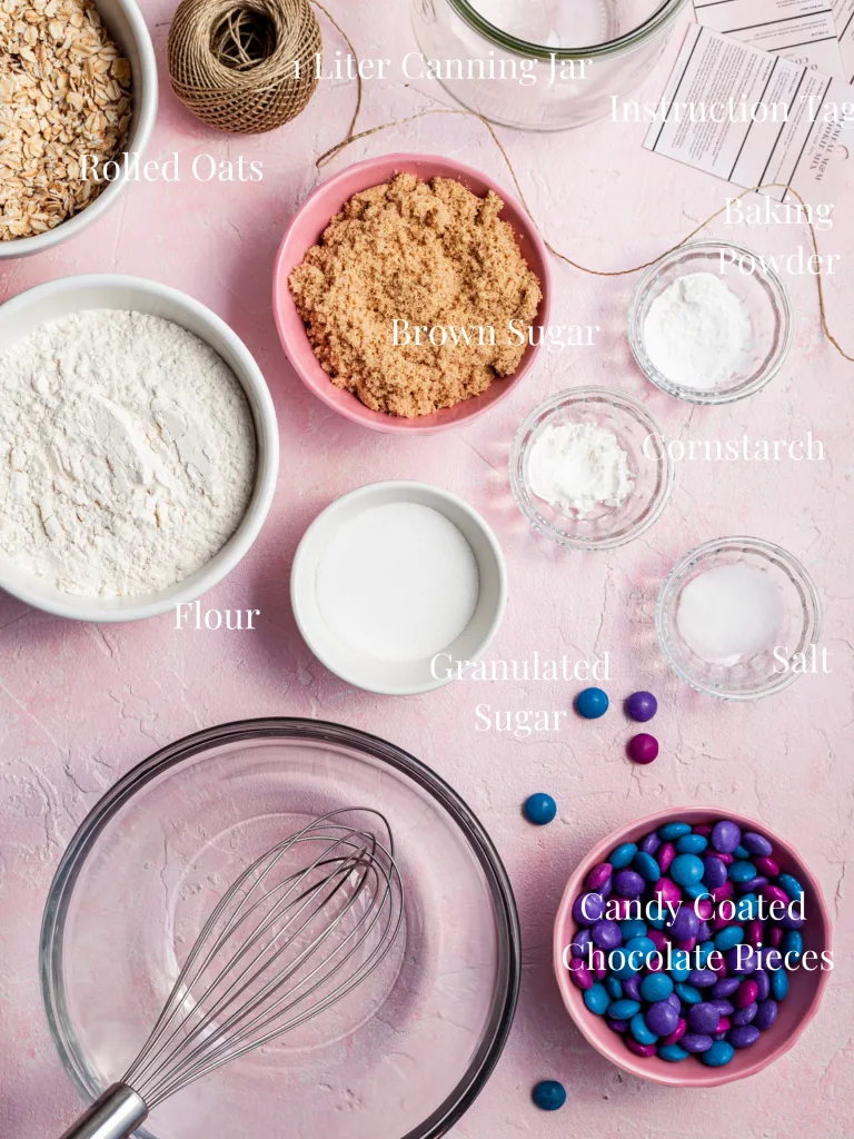 An image labelled with the ingredients, equipment and supplies needed to make cookie kit jar gifts. 