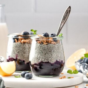 Breakfast parfaits made of chia pudding layer over blueberry compote served in small jars