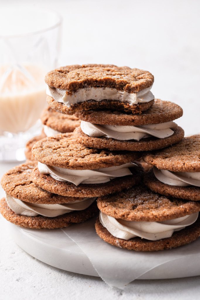 A white plate stacked with molasses sandwich cookies