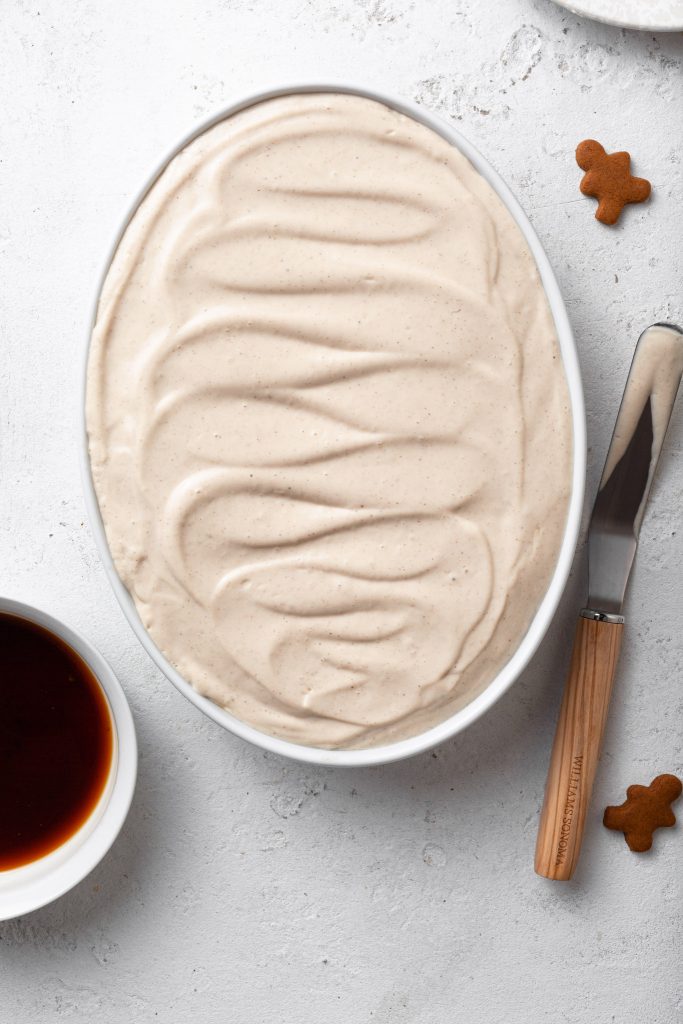 A creamy filling spread in a baking dish with a pretty swirling back and forth pattern. 