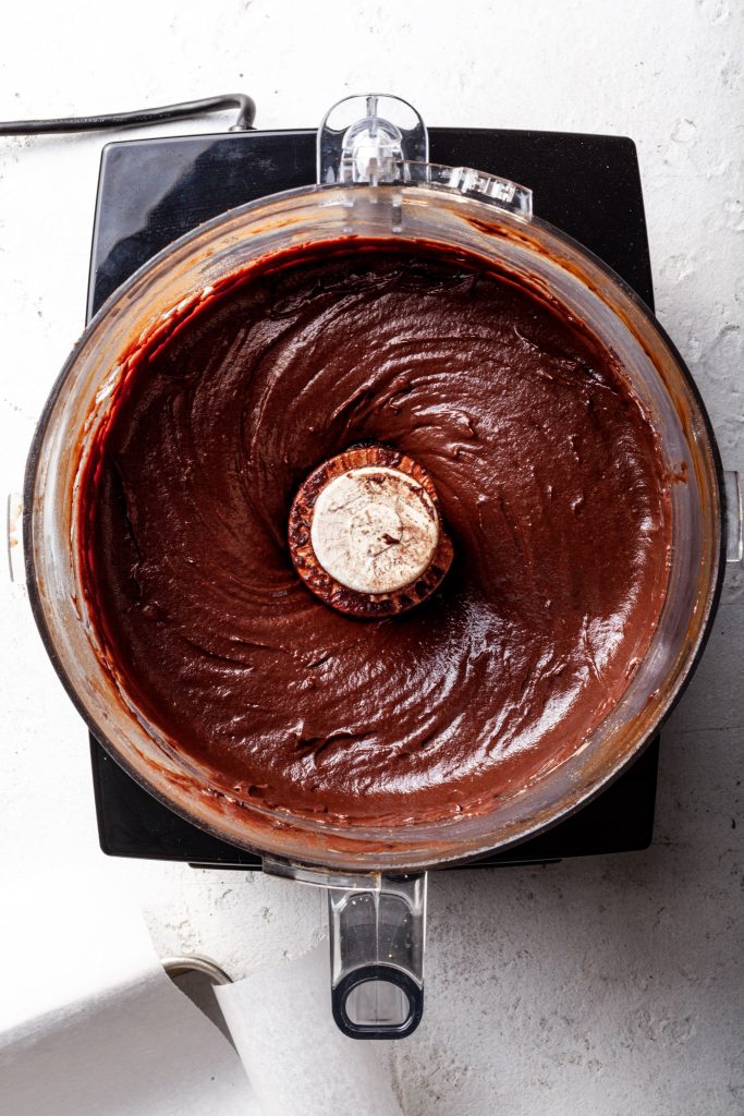 A food processor filled with chocolate brownie batter.